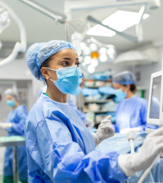 Nurse assists in the OR