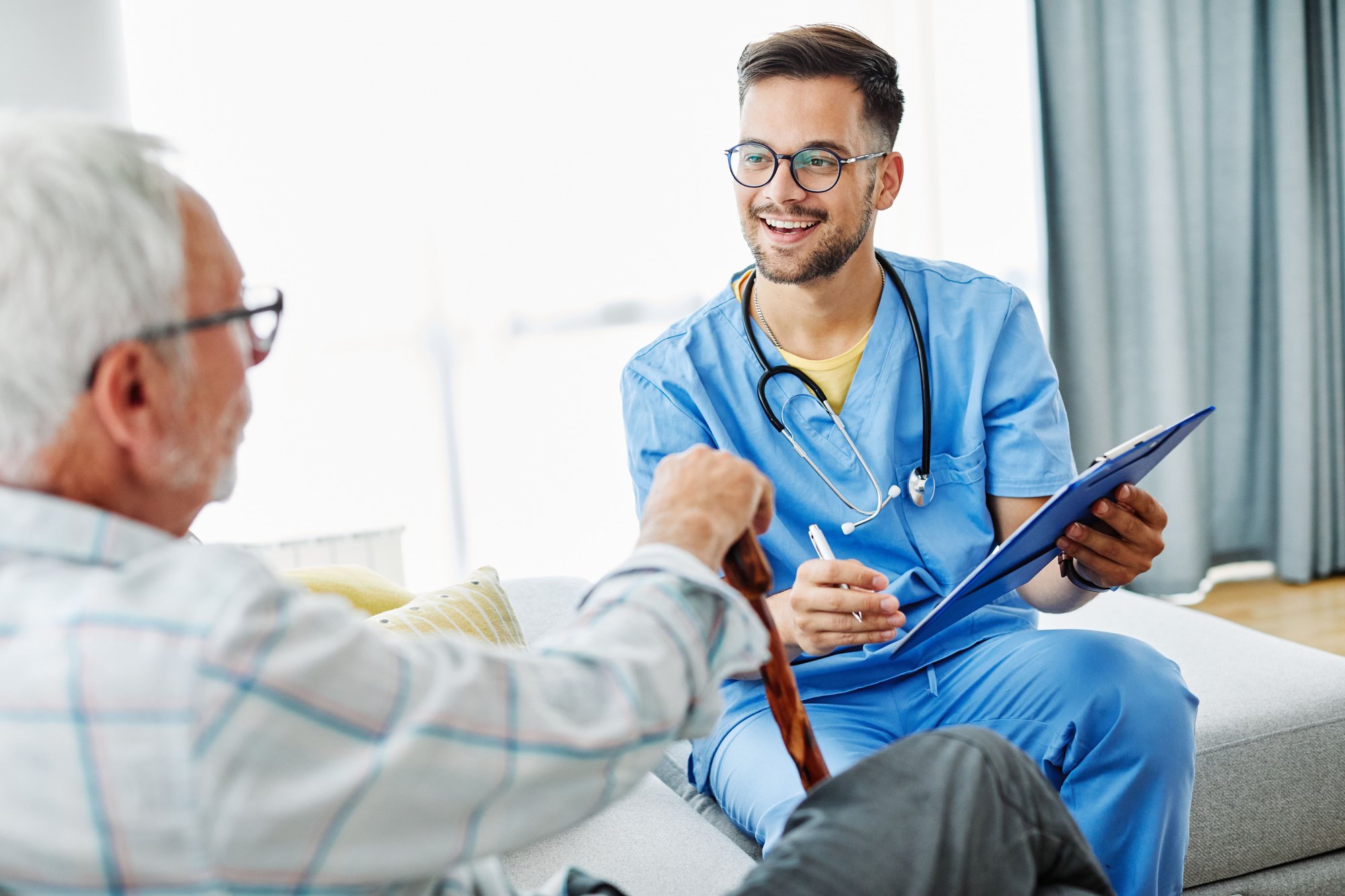 nurse talking to older man-min